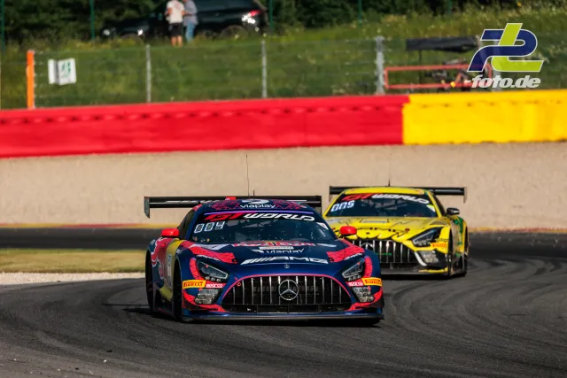 Mercedes-AMG GT3 EVO #3 führt gelbes Fahrzeug durch Kurve beim 24h-Rennen Spa-Francorchamps mit Kiesbett und Streckenbegrenzung.