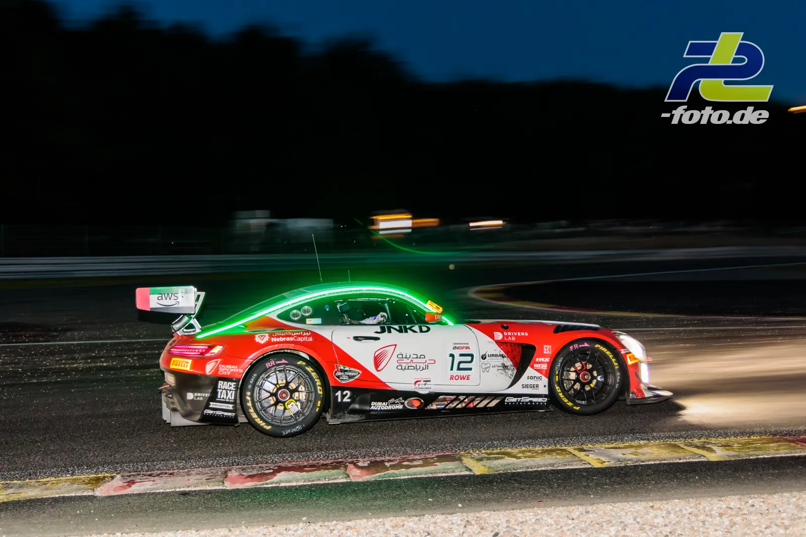 Porsche 911 GT3 R mit Startnummer 12 in der Dämmerung beim 24-Stunden-Rennen in Spa-Francorchamps, aufgenommen als Mitzieher mit Bewegungsunschärfe