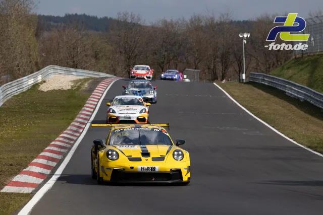 Eine Gruppe von Rennfahrzeugen fährt während des Rennens auf der Nordschleife über eine Kuppe.