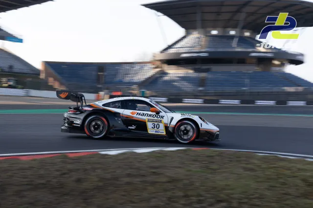 Porsche 911 GT3 Cup Nr. 30 in Weiß-Orange beim Zeittraining am Nürburgring, aufgenommen als Mitzieher vor der Tribüne.