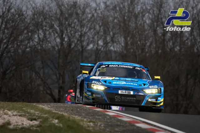 Blauer Audi R8 LMS GT3 mit Startnummer 16 in Kuppe auf der Nordschleife, Hintergrund kahle Bäume