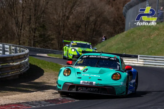 Türkisfarbener Porsche 911 GT3 R mit Falken-Schriftzug führt vor neongrünem Porsche durch Kurve auf der Nordschleife des Nürburgrings.