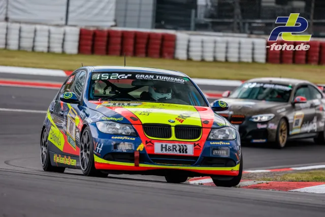 BMW 3er in bunter Lackierung führt ein Verfolgerfeld durch eine Kurve beim 24h-Rennen Nürburgring Qualifying.