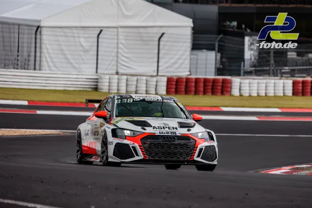 Audi in weiß-roter Lackierung fährt durch eine Kurve auf dem Nürburgring beim Qualifying zum 24h-Rennen.