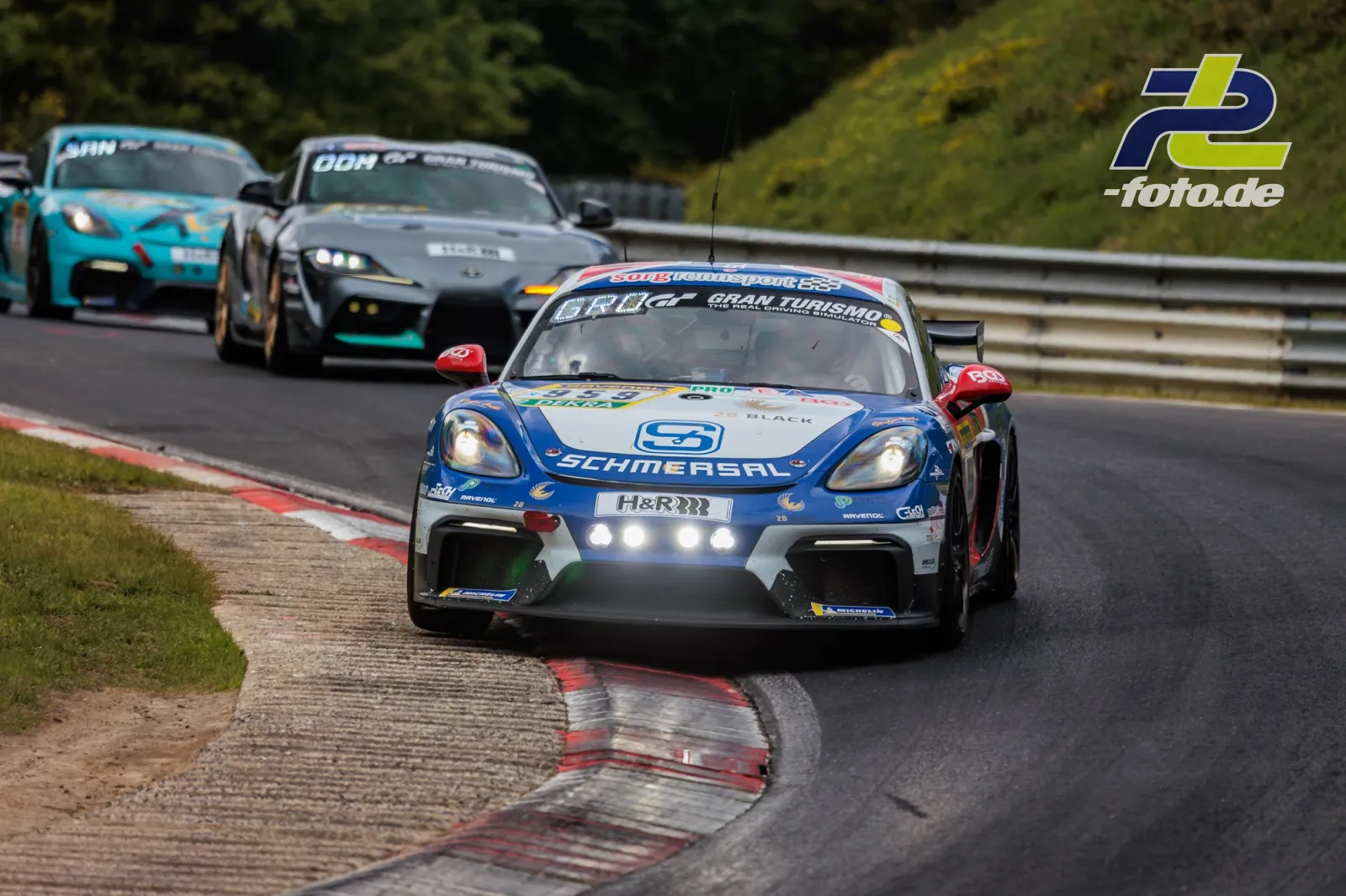Drei Rennwagen durchfahren eine Kurve auf der Nordschleife des Nürburgring während des 24h-Rennens.