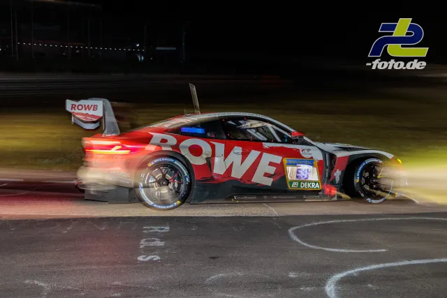 BMW M4 GT3 in ROWE-Lackierung fährt nachts über die Strecke des 24h Nürburgring-Rennens, Startnummer 99.